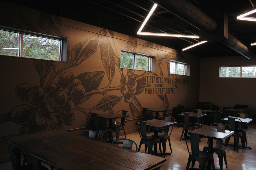 Lafayette Café interior seating with coffee plant mural