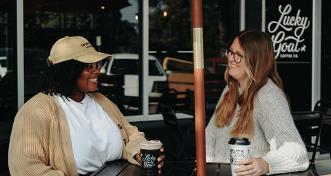 Two friends enjoying the outdoor patio at Lucky Goat's Lafayette Café